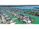 Expansive aerial view of waterfront homes lining canals, with private docks, providing direct access to the open bay at 501 Crystal Dr, Madeira Beach, FL 33708