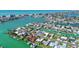 Picturesque aerial view of waterfront homes on canals, showcasing the coastal lifestyle and boating opportunities at 501 Crystal Dr, Madeira Beach, FL 33708