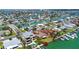 Bright aerial shot displaying canal-front home sites in a lovely waterfront community, offering pool and water access at 501 Crystal Dr, Madeira Beach, FL 33708