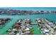 Bright aerial shot displaying canal-front home sites in a lovely waterfront community, offering pool and water access at 501 Crystal Dr, Madeira Beach, FL 33708