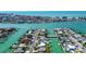 Stunning aerial view of waterfront homes with docks and canals, showcasing the coastal community and access to open water at 501 Crystal Dr, Madeira Beach, FL 33708