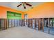 Unfinished bedroom featuring bright orange walls, a ceiling fan, and a doorway to the outdoors at 501 Crystal Dr, Madeira Beach, FL 33708