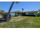 Inviting single-story home featuring a neatly kept lawn and a convenient attached garage at 501 Crystal Dr, Madeira Beach, FL 33708