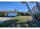Charming single-story home with a well-manicured lawn and attached garage at 501 Crystal Dr, Madeira Beach, FL 33708