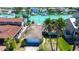 Charming single-Gathering home featuring a tile roof, two-car garage, and palm trees in a waterfront community at 501 Crystal Dr, Madeira Beach, FL 33708