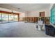 Open-concept living room ready for renovation, with large sliding glass doors at 501 Crystal Dr, Madeira Beach, FL 33708