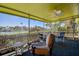 Relaxing screened patio with ceiling fan, chairs, and a picturesque waterfront view at 501 Crystal Dr, Madeira Beach, FL 33708