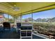 Relaxing screened patio with ceiling fan, chairs, and a table with a picturesque waterfront view at 501 Crystal Dr, Madeira Beach, FL 33708