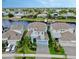 Aerial view of a blue two-story home on a canal with a private dock and lush landscaping at 5307 Wishing Arch Dr, Apollo Beach, FL 33572