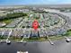Aerial view of canal community featuring a blue two-story home on a canal with a private dock at 5307 Wishing Arch Dr, Apollo Beach, FL 33572