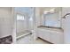 Bright bathroom featuring a glass enclosed shower with white subway tile and a large vanity at 5307 Wishing Arch Dr, Apollo Beach, FL 33572