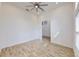 Bright bedroom with wood-look tile flooring, ceiling fan, and large window offering plenty of natural light at 5307 Wishing Arch Dr, Apollo Beach, FL 33572