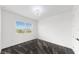 Bright bedroom features neutral carpeting, a modern ceiling fan, and a window overlooking the neighborhood at 5307 Wishing Arch Dr, Apollo Beach, FL 33572