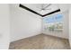 Bright, modern bedroom with wood floors, tray ceilings, contemporary ceiling fan, and large windows at 5307 Wishing Arch Dr, Apollo Beach, FL 33572