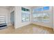 Sunlit dining area with tile floors, modern lighting, and sliding glass doors to the patio at 5307 Wishing Arch Dr, Apollo Beach, FL 33572