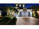 Front exterior of a two-story home with a large garage, brick driveway, and landscaping at 5307 Wishing Arch Dr, Apollo Beach, FL 33572