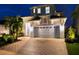 Exterior of two-story home with garage, landscaping, and brick paver driveway at 5307 Wishing Arch Dr, Apollo Beach, FL 33572
