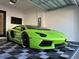 Modern garage with a green Lamborghini, sleek design, and contemporary tiled flooring at 5307 Wishing Arch Dr, Apollo Beach, FL 33572
