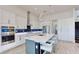 Modern kitchen with stainless steel appliances, sleek cabinetry, and spacious island with seating at 5307 Wishing Arch Dr, Apollo Beach, FL 33572