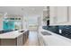 Modern kitchen features a large island, stainless steel appliances, and stylish backsplash at 5307 Wishing Arch Dr, Apollo Beach, FL 33572
