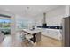Bright, open kitchen boasts an island, modern stainless steel appliances, and beautiful views at 5307 Wishing Arch Dr, Apollo Beach, FL 33572