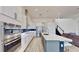Gourmet kitchen features stainless steel appliances, a center island, and sleek cabinetry at 5307 Wishing Arch Dr, Apollo Beach, FL 33572