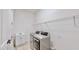 Convenient laundry room featuring modern washer and dryer, a sink, and storage shelves at 5307 Wishing Arch Dr, Apollo Beach, FL 33572