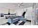 Spacious living room featuring a comfortable gray sectional couch, modern lighting, and staircase at 5307 Wishing Arch Dr, Apollo Beach, FL 33572