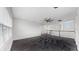 Spacious loft area with plush carpeting, ceiling fan, and plenty of natural light from the windows at 5307 Wishing Arch Dr, Apollo Beach, FL 33572