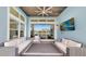 Screened-in lanai featuring comfortable seating, wood ceiling, a television, and a view of the water at 5307 Wishing Arch Dr, Apollo Beach, FL 33572