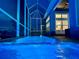 An indoor pool is surrounded by a screened enclosure with an ocean view at 5307 Wishing Arch Dr, Apollo Beach, FL 33572