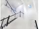 Elegant staircase with dark wood and white railing leads to the upper level of the home at 5307 Wishing Arch Dr, Apollo Beach, FL 33572