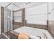 Bathroom featuring a soaking tub, glass enclosed shower and window at 5422 Braddock Dr, Zephyrhills, FL 33541