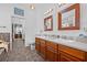 Spacious bathroom featuring a double sink vanity, framed mirrors and tile floors at 5422 Braddock Dr, Zephyrhills, FL 33541