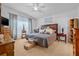 Comfortable bedroom features neutral paint, and a decorative ceiling fan with lighting at 5422 Braddock Dr, Zephyrhills, FL 33541