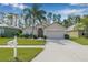 Inviting single-Gathering home with a neatly manicured front lawn and spacious two-car garage at 5422 Braddock Dr, Zephyrhills, FL 33541