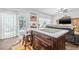 Open-concept kitchen with an island and a breakfast bar, seamlessly connected to the living area at 5422 Braddock Dr, Zephyrhills, FL 33541