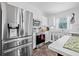 Bright kitchen featuring stainless steel appliances, white cabinetry, and tiled floors at 5422 Braddock Dr, Zephyrhills, FL 33541