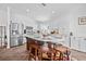 Bright kitchen featuring white cabinets, stainless steel appliances, and a functional center island with seating at 5422 Braddock Dr, Zephyrhills, FL 33541