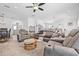Expansive living area with plenty of seating, soft lighting, and easy access to other living spaces at 5422 Braddock Dr, Zephyrhills, FL 33541