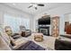 Comfortable living area with a fireplace, entertainment center, and cozy seating, ideal for relaxation at 5422 Braddock Dr, Zephyrhills, FL 33541