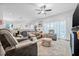 Open-concept living space with a cozy seating area, natural light, and seamless access to other parts of the house at 5422 Braddock Dr, Zephyrhills, FL 33541