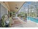 Covered patio with ceiling fan, outdoor rugs, and screened in lanai overlooking a pool at 5422 Braddock Dr, Zephyrhills, FL 33541