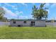 Expansive, well-maintained backyard with lush green grass and a privacy fence at 5741 91St N Ave, Pinellas Park, FL 33782
