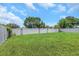 Picturesque backyard featuring a green lawn, bordered by a tall, white privacy fence at 5741 91St N Ave, Pinellas Park, FL 33782