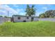 Large backyard featuring green lawn space and a white fence for added privacy at 5741 91St N Ave, Pinellas Park, FL 33782