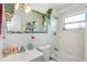Bathroom with a marble-themed wall, decorated mirror, and bathtub with showerhead at 5741 91St N Ave, Pinellas Park, FL 33782