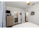 Bedroom with dresser, TV, and adjoining bathroom with a vanity at 5741 91St N Ave, Pinellas Park, FL 33782
