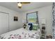Cozy bedroom featuring a ceiling fan, window with blinds, and floral bedding at 5741 91St N Ave, Pinellas Park, FL 33782