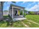 Single-story home with a covered carport and vibrant yellow front door surrounded by greenery at 5741 91St N Ave, Pinellas Park, FL 33782